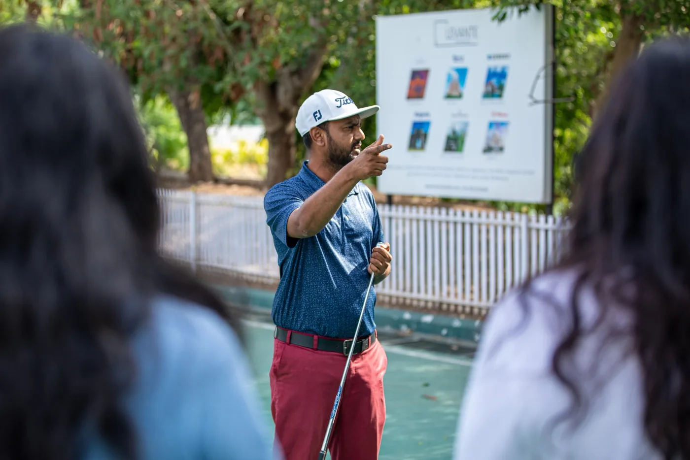 A golf coach demonstrating technique to GCC Mixer guests