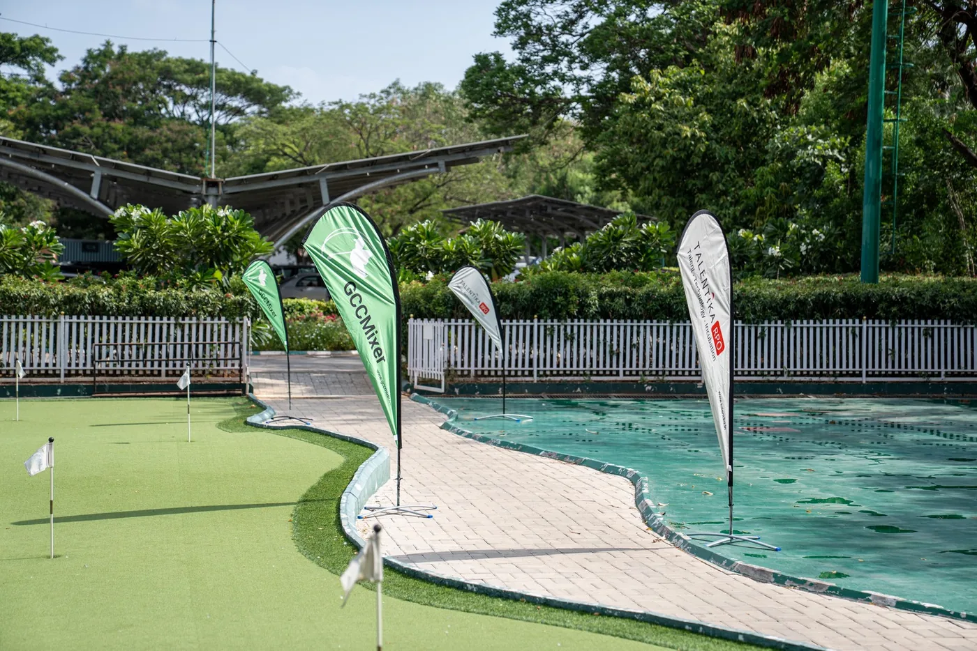 The practice green prepared with GCC Mixer event flags